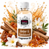 A bottle of Fizzy Whiz Amber & Sandalwood Fragrance Oil centered against a white background, surrounded by decorative amber crystals, cinnamon sticks, white flowers, and a stylized golden splash graphic.