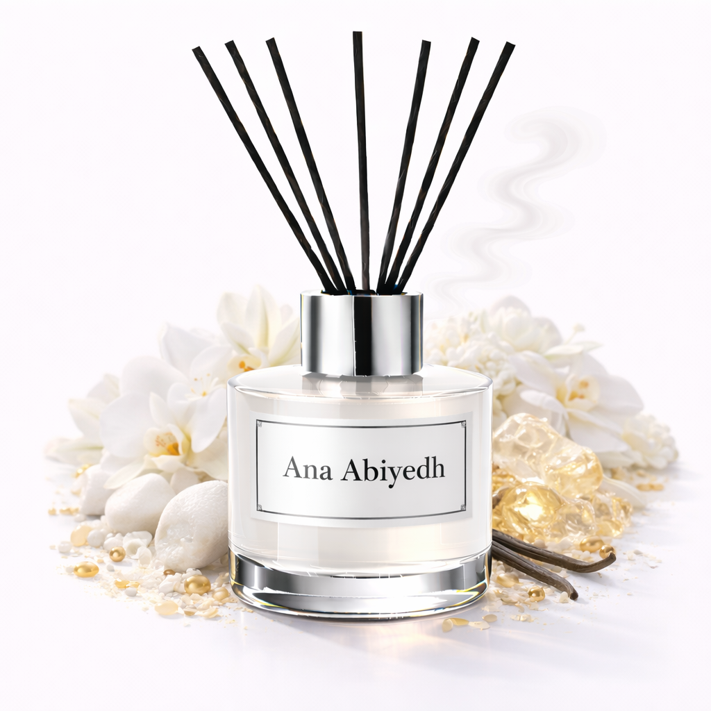 Reed diffuser with black sticks and 'Ana Abiyedh' label on a white background