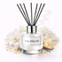 Reed diffuser with black sticks and 'Ana Abiyedh' label on a white background