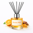 Reed diffuser with 'Ancient Mehr' label, orange, almonds, and ginger on a white background