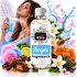 A bottle of Fizzy Whiz 'Angels' fragrance oil centered on a white background, surrounded by themed props including a woman spraying perfume, flowers, honey, chocolates, vanilla, and blue water splash graphics. The product bottle has a white cap and white label with black and pink branding.