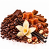 A styled food arrangement of chocolate ingredients and sweets on a white background, including coffee beans, dark chocolate chunks, caramel cubes, cinnamon sticks, vanilla beans, hazelnuts, cocoa powder, and a white orchid flower.