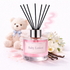 Reed diffuser labeled 'Baby Lotion' with a teddy bear and flowers on a light background