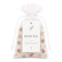 Bath tea package with drawstring and decorative elements on a white background