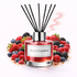 Reed diffuser labeled 'Berry Comfort' surrounded by berries on a white background