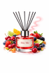Reed diffuser labeled 'Bite Me' surrounded by fruits on a white background