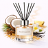 Reed diffuser labeled 'Black Coconut' with coconuts, flowers, and vanilla beans in the background.