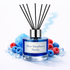 Reed diffuser labeled 'Blue Raspberry Slushy' with decorative berries on a white background