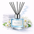 Diffuser bottle labeled 'Blue Skies' with black reeds and white flowers in the background