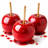 Three glossy red candy apples with wooden sticks, coated in a sparkling red glaze and dripping with syrup on a white background.