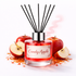Reed diffuser labeled 'Candy Apple' with red apples and apple pieces on a white background