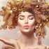 A person with closed eyes and lips pursed, wearing a festive headpiece adorned with gold and bronze ornaments, giving a Christmas kiss.