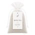 Bath tea clay mineral bath soak in a drawstring bag with a label on a white background