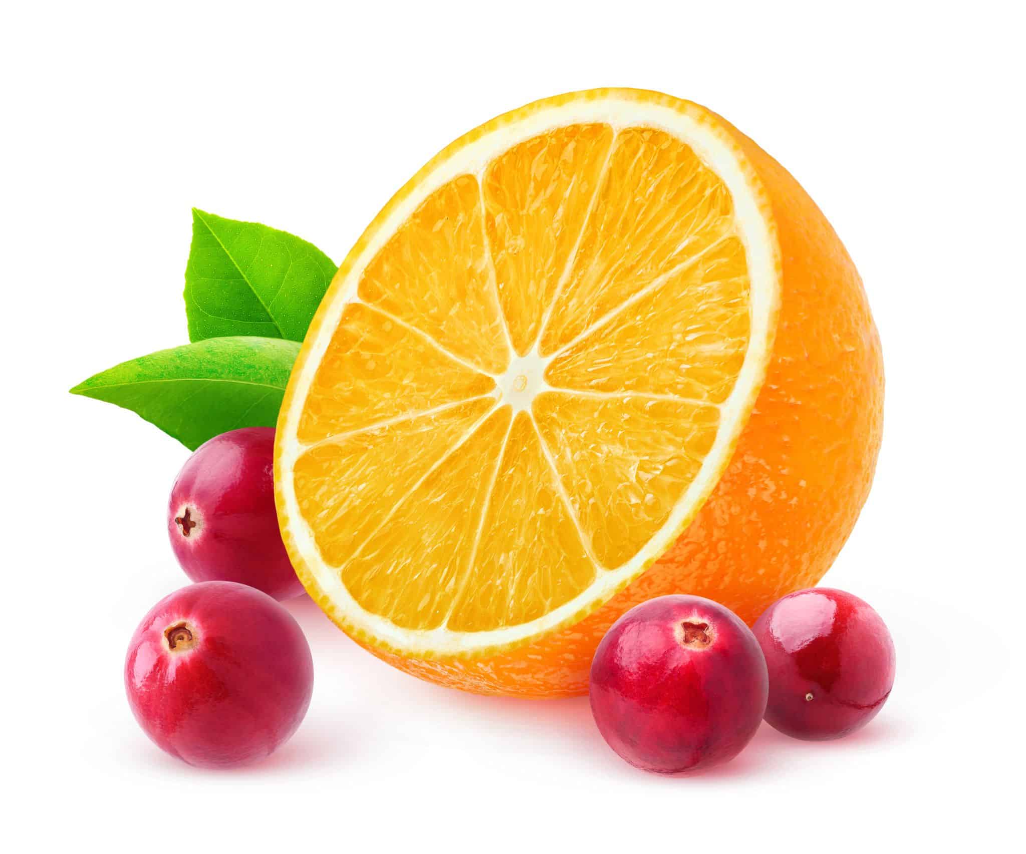 A composition of fresh cranberries and a half slice of orange with leaves, representing the cranberry and orange fragrance oil.