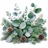 Frosted green eucalyptus and pine branches with two brown pinecones, arranged as a decorative greenery arrangement on a white background.