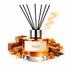 Reed diffuser labeled 'Hero' with cinnamon sticks and orange peel on a white background