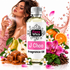 A bottle of Fizzy Whiz 'J Choo' fragrance oil is centered against a white background, surrounded by decorative ingredients and scent notes including oranges, pears, flowers, and caramel. A woman is visible in the background spraying perfume.