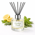 Diffuser with 'Kitchen Fresh' label surrounded by lemons and herbs on a white background
