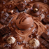 A close-up of a rich chocolate dessert spread with a large scoop of chocolate ice cream or gelato in the center, drizzled with chocolate sauce. Surrounding it are chocolate chunks, cocoa powder, small mounds of cream with chocolate sprinkles, iridescent bubbles, and a small chocolate duck toy.