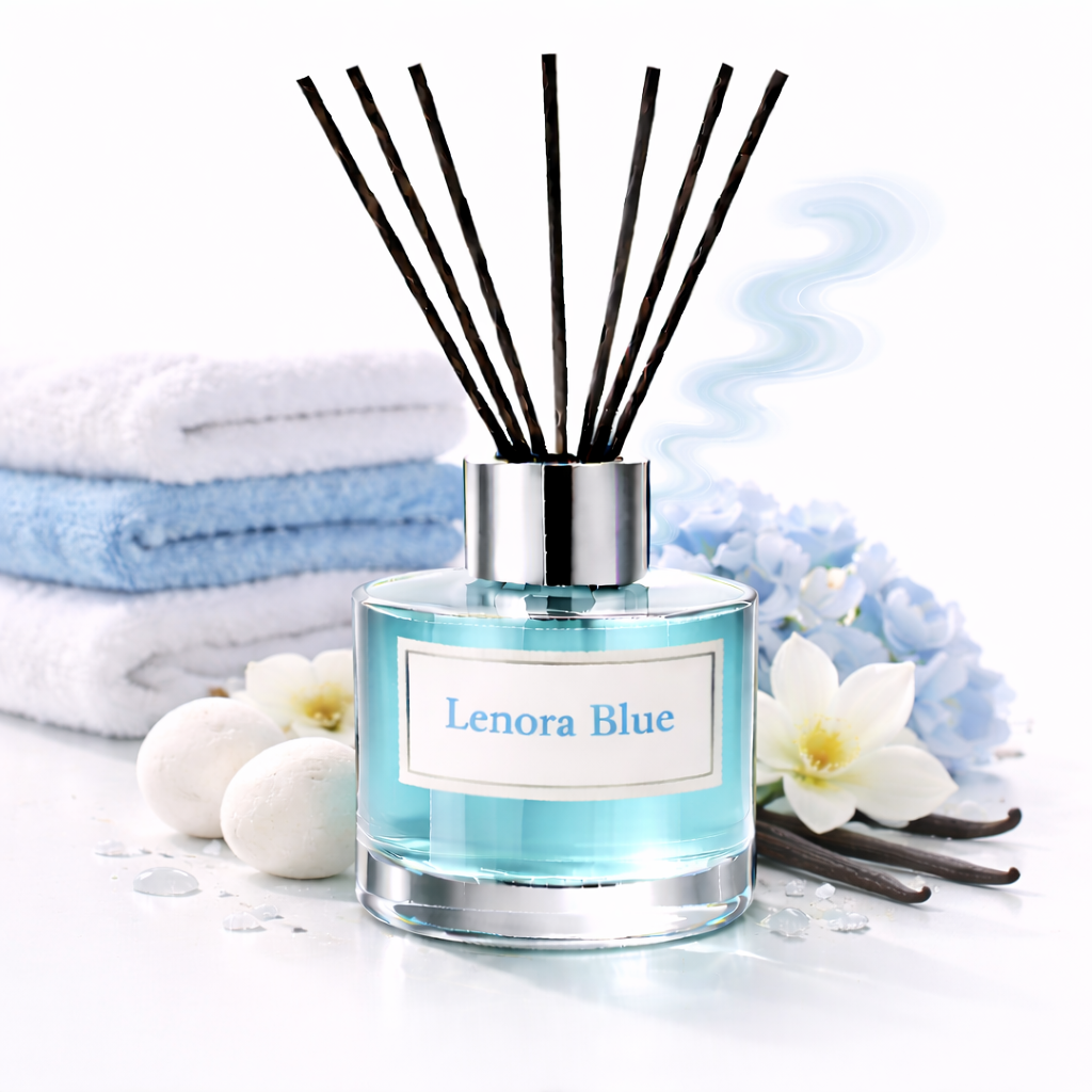Lenora Blue Reed Diffuser Oil with towels, blue flowers and vanilla pods on a white background