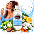 A bottle of Fizzy Whiz Light Blue Fragrance Oil centered in a stylized commercial composition, surrounded by citrus, green apple, white blossoms, blue water graphics, and a woman spraying the fragrance oil. The product label reads 'Fizzy Whiz' and 'Light Blue Fragrance Oil.