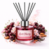 Reed diffuser labeled 'Lost Cherry' with cherry and almond decorations on a white background