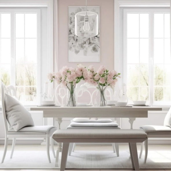 Dining room with a table, chairs, and pink flowers in a vase.