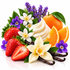 A styled botanical arrangement of vanilla extract ingredients and flowers on a white background, including vanilla beans, sliced strawberries, whole and orange slices, purple flowers, white blossoms, and green leaves.