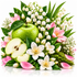 A vibrant spring floral arrangement featuring a whole and sliced green apple, white lily of the valley flowers, pink blossoms, green leaves, and delicate white flowers on a clean white background.