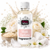 A bottle of Fizzy Whiz Musk Perfume Fragrance Oil centered against a white background, surrounded by decorative props including white roses, baby's breath, cotton balls, crystals, and a splash of liquid. The bottle has a white cap and a white label with pink and black text.