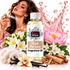 A bottle of Fizzy Whiz Musk Perfume Fragrance Oil is centered against a white background, surrounded by decorative elements including a woman spraying perfume, pink lotus flowers, white orchids, vanilla beans, cinnamon sticks, and a pink liquid splash graphic.