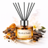 Reed diffuser labeled 'Myrrh & Tonka' with ingredients on a white background