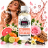 A bottle of Fizzy Whiz Olympia Fragrance Oil centered in a styled product composition, surrounded by pink roses, citrus fruits, vanilla beans, wood chips, and perfume spray, with a woman holding a perfume bottle in the background and a pink liquid splash graphic on a white backdrop.