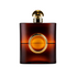 Dark amber glass perfume-style bottle with rounded square shape, gold cap, and circular centre detail, shown upright on a light background.