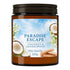 An amber glass jar candle with a dark brown screw-on lid and a colorful label reading 'PARADISE ESCAPE COCONUT & SANDALWOOD Wax Candle 205g'. The label features a blue sky background with white clouds, images of coconuts, and sandalwood pieces.
