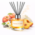 Reed diffuser labeled 'Peaches & Cream' with peaches and vanilla beans on a white background