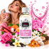 A bottle of Fizzy Whiz Perfect Elixir Fragrance Oil stands in the center, surrounded by pink roses, flowers, fruit, vanilla beans, amber crystals, and a woman holding a perfume spray bottle on the left. Pink liquid splashes and droplets decorate the white background.