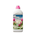 White plastic bottle with a pink screw cap and floral label featuring pink tulips and white flowers, shown upright on a light background.