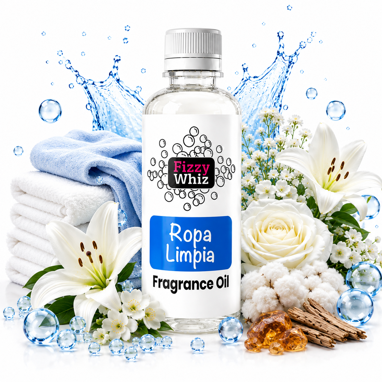 A bottle of Fizzy Whiz Ropa Limpia Fragrance Oil centered on a white background, surrounded by folded white and blue towels, white lilies, white roses, cotton buds, amber pieces, and blue water droplets/splash effects. The bottle label is white with a blue rectangular section and black text.