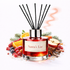 Reed diffuser labeled 'Santa's List' surrounded by fruits and spices on a white background