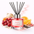 Reed diffuser labeled 'Santa's Cocktail' with fruits and candy on a white background