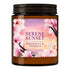 A 205g wax candle in a dark amber glass jar with a black screw-on lid. The front label features pink magnolia flowers and vanilla beans against a sunset sky background, with the text 'SERENE SUNSET', 'MAGNOLIA & VANILLA', and 'Wax Candle 205g'.