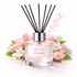 Silk Tree Blossom Reed Diffuser Oil with pink flowers and leaves on a white background