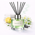 Reed diffuser labeled 'Spanish Pet' with lemons, vanilla beans, and flowers on a white background