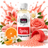 A bottle of Fizzy Whiz Spring Fragrance Oil centered on a white background, surrounded by decorative spring-themed props including pink roses, lilies, orange slices, folded towels, spilled pink beads, and a pink splash graphic.