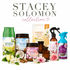 A collection of home fragrance products from Stacey Solomon, including an air freshener, candles, reed diffusers, and room sprays, arranged on a white background with decorative flowers and text reading 'STACEY SOLOMON collection'.