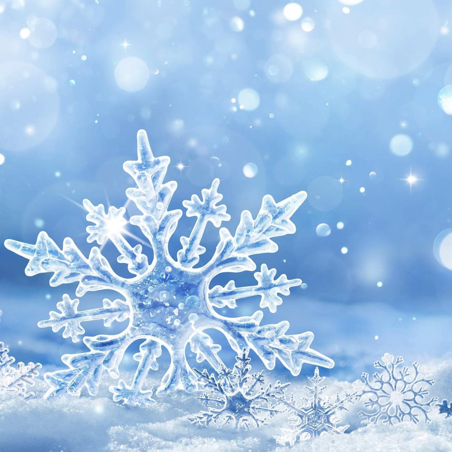 A close-up image of a snowflake with a fragrant oil bottle in the background, suggesting the product is a fragrance oil with a winter theme.