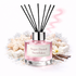 Diffuser bottle labeled 'Sugar Dusted Snowflakes' with black sticks on a white background