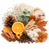 A styled flat-lay of cozy autumn and winter ingredients on a white background, including cinnamon sticks, orange slices, cloves, pinecones, dried leaves, baby's breath, eucalyptus, amber resin, and a cream knit blanket.