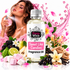 A bottle of Fizzy Whiz Sweet Like Candies fragrance oil is centered in front of a woman spraying perfume, surrounded by pink flowers, fruit, marshmallows, vanilla, and candy-themed decorative elements on a white background.